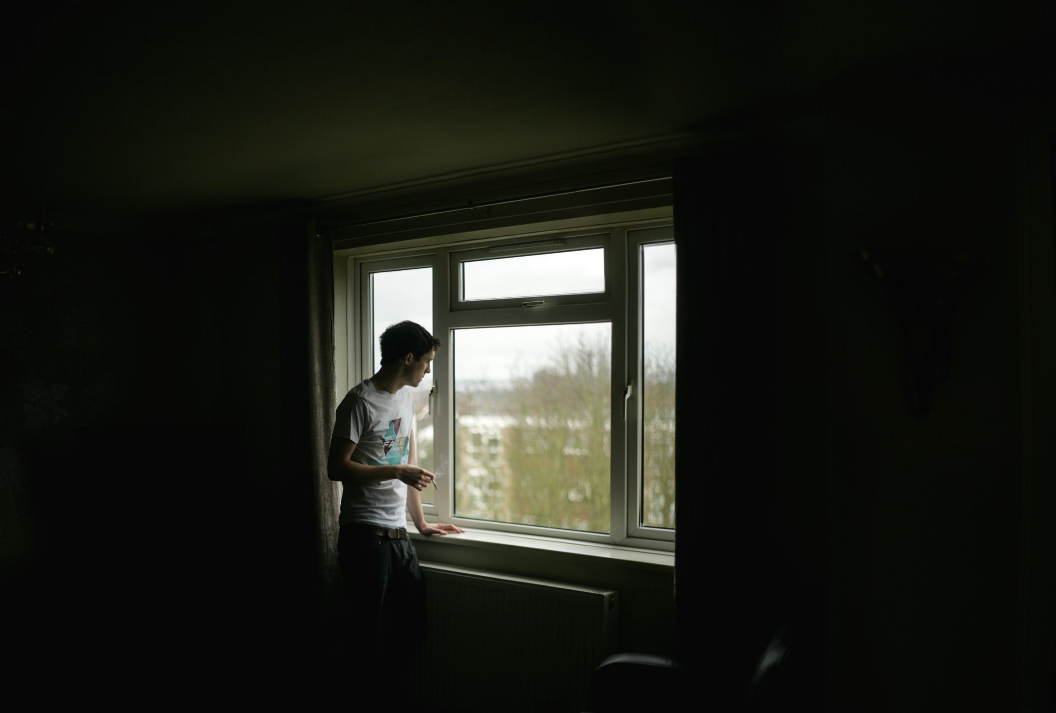man looking out window