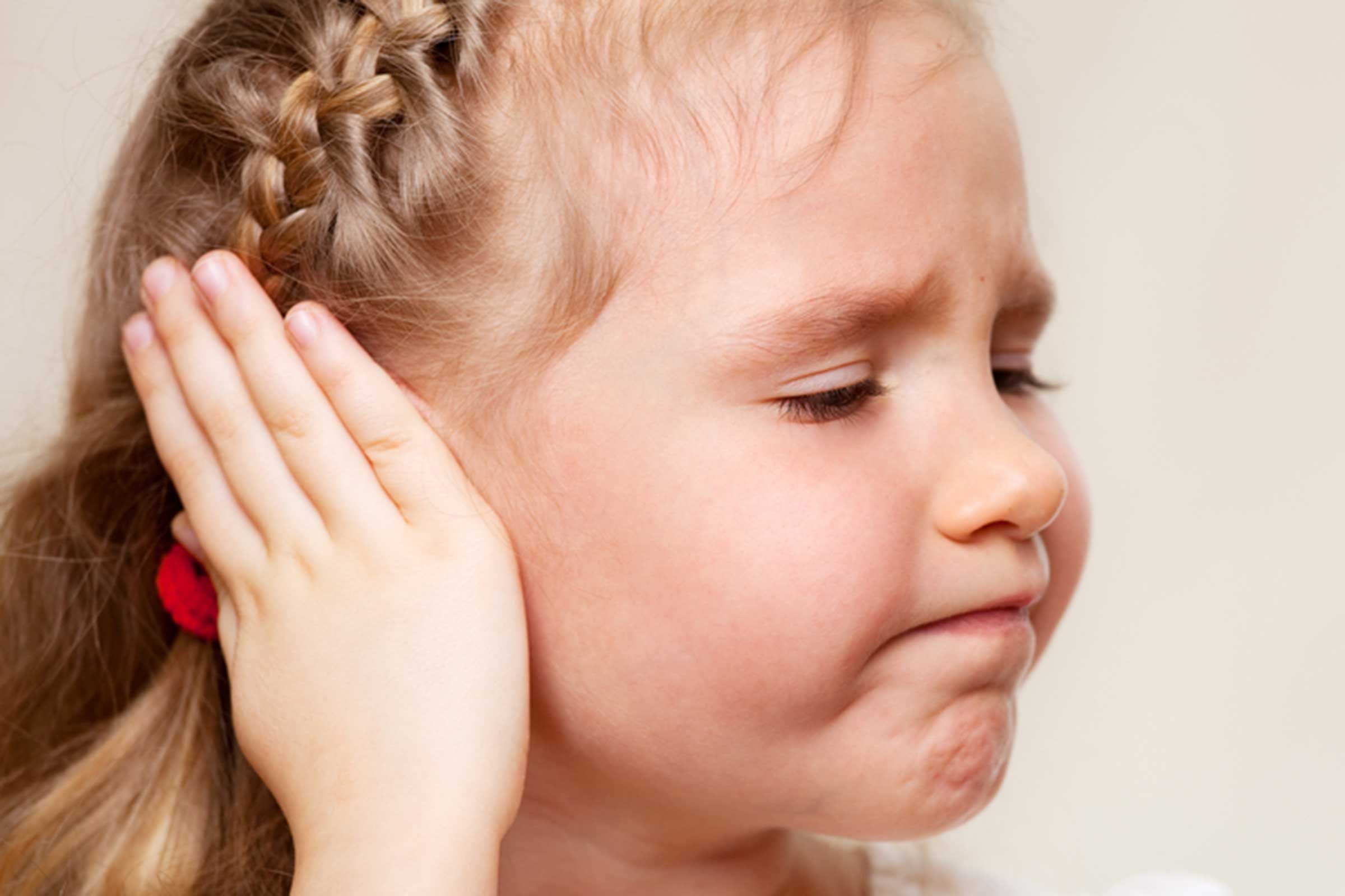 girl with hand over ear