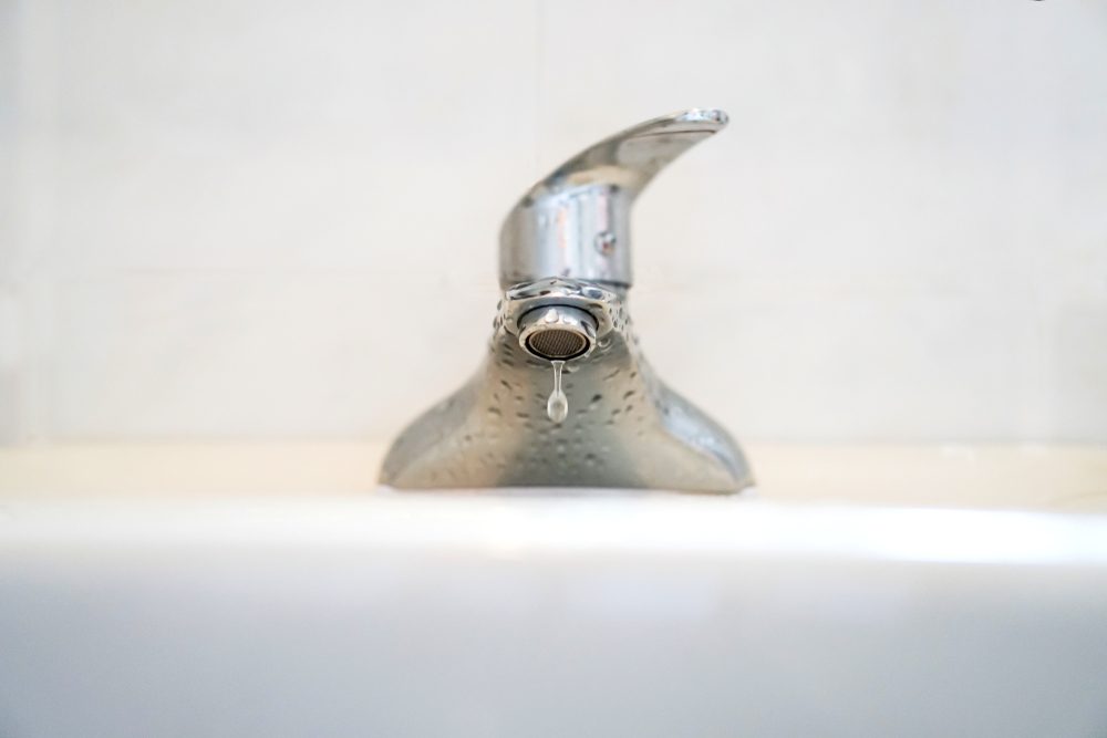 Faucet with water.Drop of water.