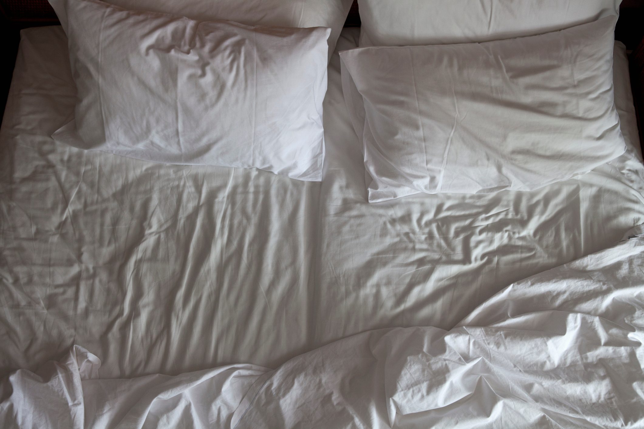 Detail of an unmade double bed