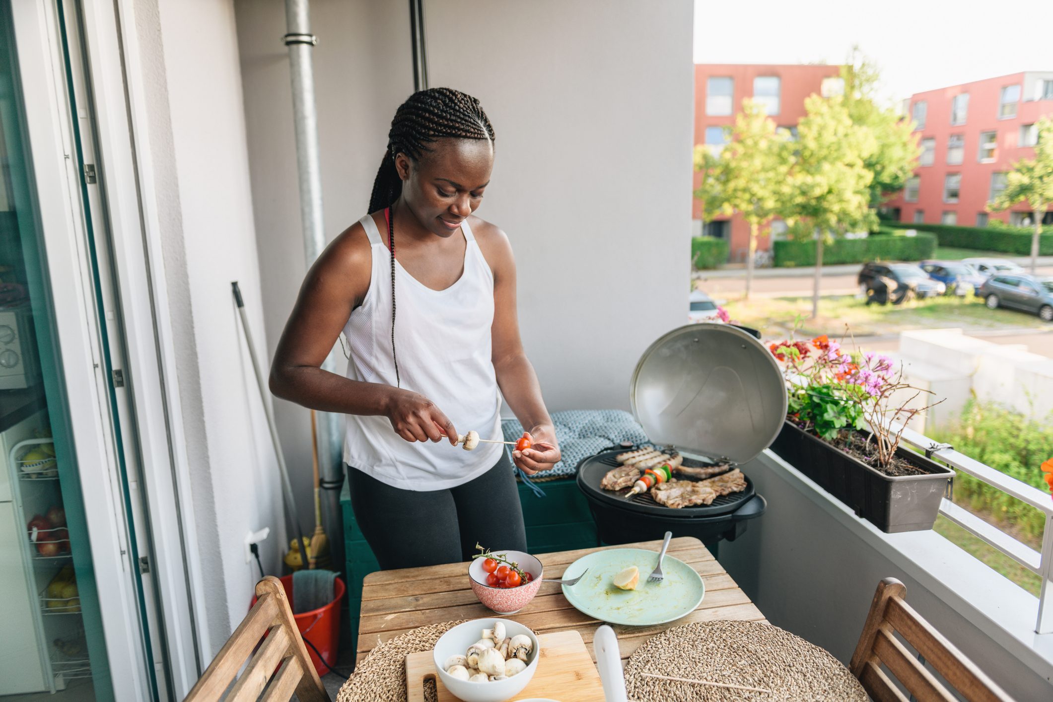 woman preparing vegetarian skewers fot barbecue grill