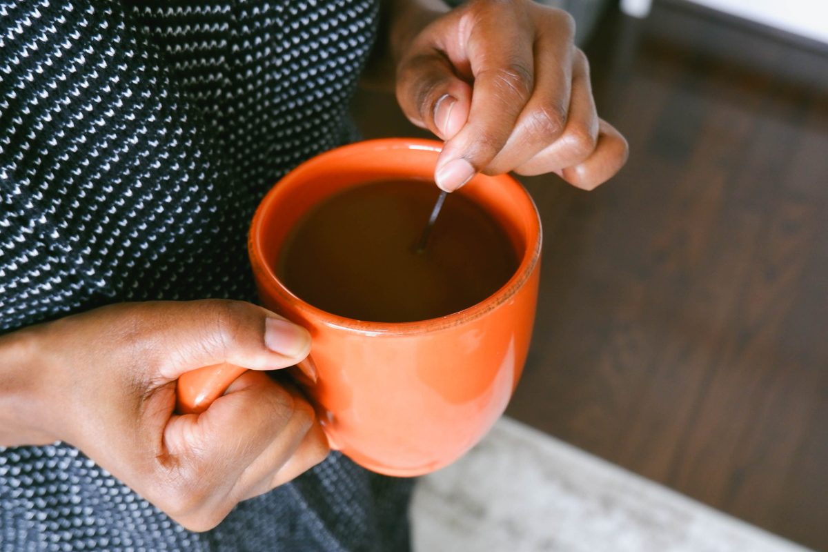 hands holding cup of coffee