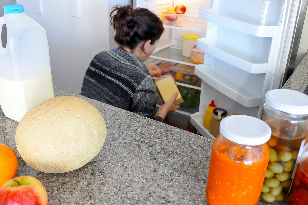 woman cleaning her fridge