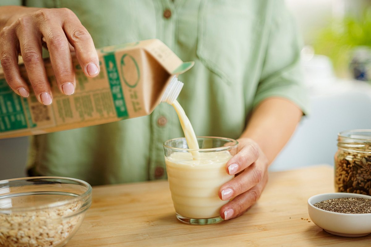 woman pouring milk into glass