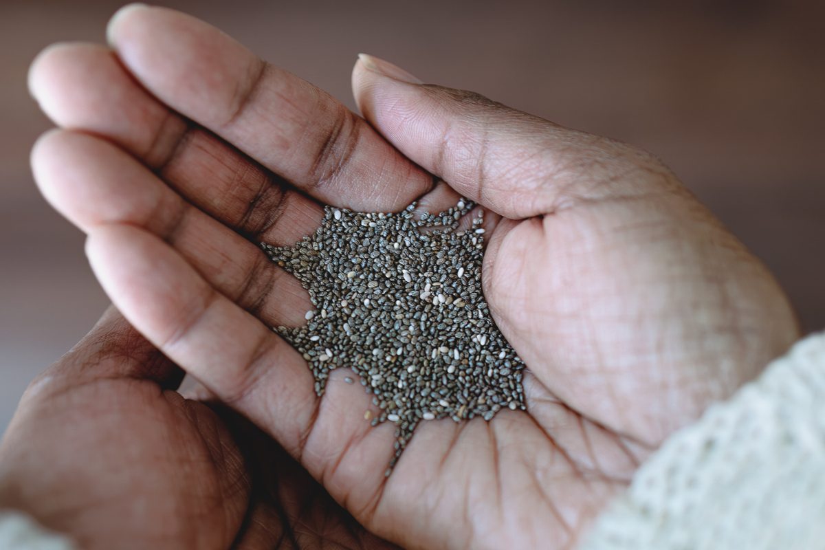 close up of chia seeds in a persons hand